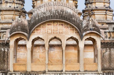 Columns and textured wall of vintage towers in hindu temple