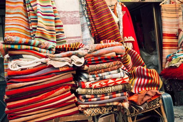 Carpets and kilims with ancient drawings in small souvenir shop of bazaar street