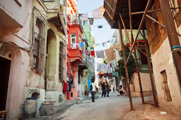 ISTANBUL - JULY 23: Poor people living in oldest streets of area Tarlabasi on July 23, 2015 in Turkey. With population of 14.4 million, Istanbul is the 5th largest city in world