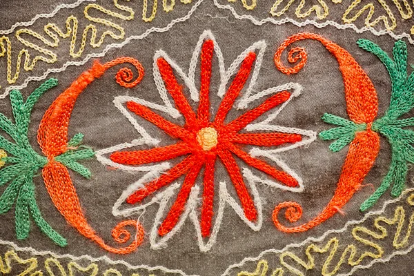 Flower or sun patterns on vintage blanket with symbols, sewn in hand-made technique — Stock Photo, Image