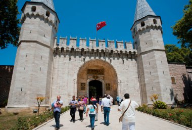 People with children walking through the gate of historical Topkapi palace, Turkey clipart
