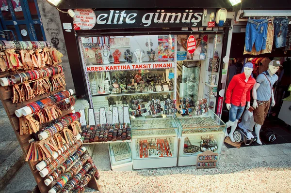 Many goods, jewelry and denim clothing on shop showcase in turkish capital — Stok fotoğraf