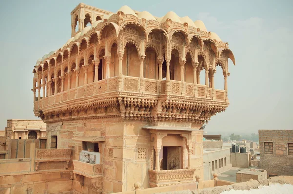 Carved tower with stone balconies of ancient indian house in old town in India — Zdjęcie stockowe