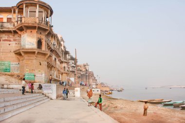 Monumental buildings under riverboats on sacred river Ganges 
