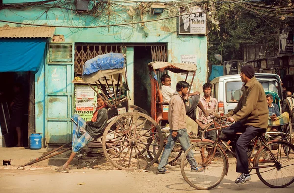 Bicyclists and pedestrians on busy street of indian city at sunny day — 图库照片