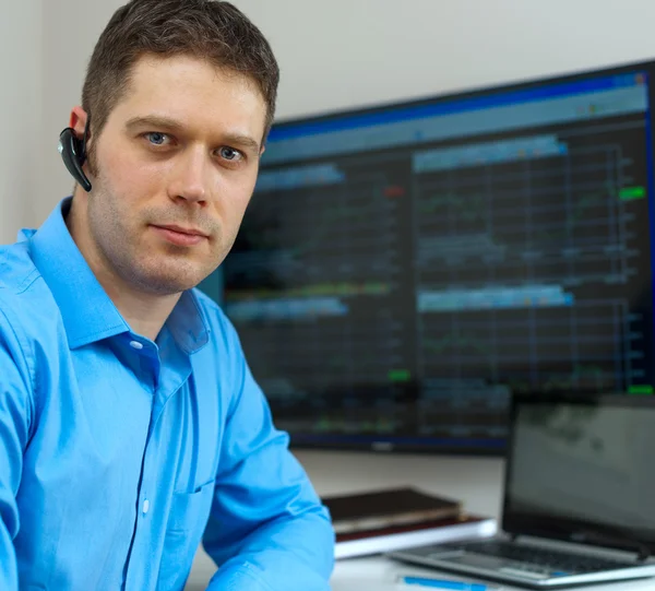 Handsome stock trader in front of computer. — Stock Photo, Image