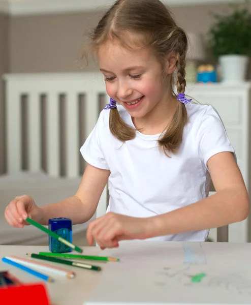 Gelukkig klein meisje tekenen met potlood thuis. — Stockfoto