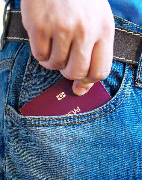 Man pulls out european passport from his pocket.