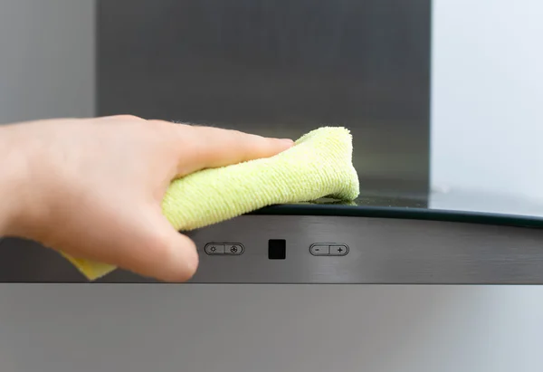 Man's hand wipes dust from exhaust hood. — Stock Photo, Image