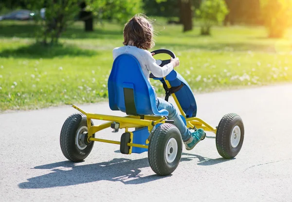 Little girl riding on pedal karting. — Stock Photo, Image