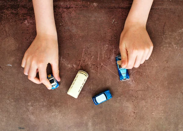 Child hands playing with miniature model cars. — Stock Photo, Image