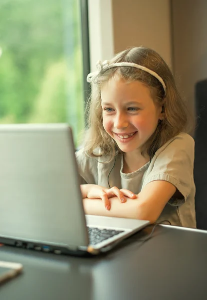 Little girl watching cartoon while traveling by train. — Stock Photo, Image