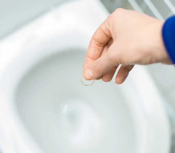 Divorce concept. Woman throwing her wedding ring in the toilet. — Stock Photo, Image