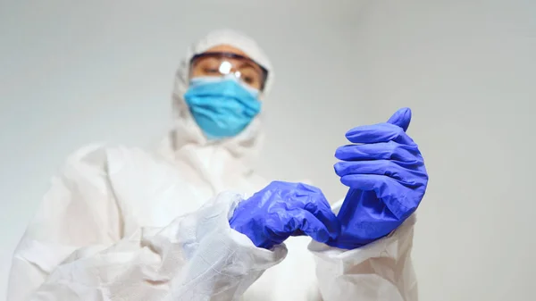 Medical Worker Protective Suit Puts Gloves — Stock Fotó