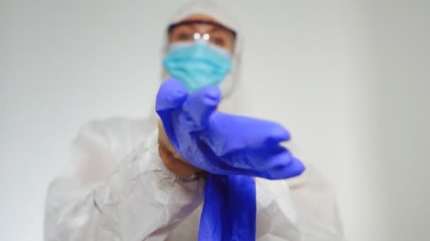 Medical Worker Protective Suit Puts Gloves — Stock Video