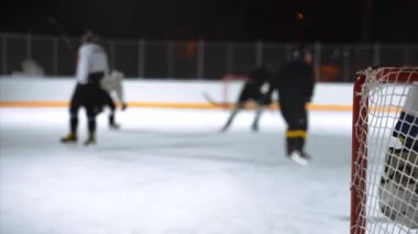 İnsanlar kışın dışarıda hokey oynarlar..