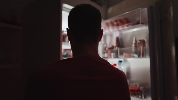 Чоловік Шукає Їжу Холодильнику Вночі — стокове відео