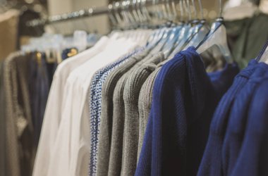 Giyim mağazasında kazaklarla dizilin..