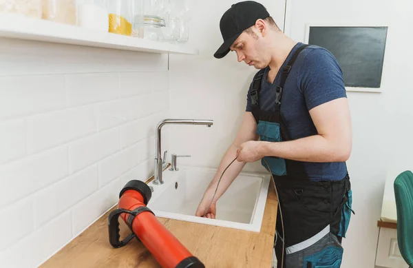 Plumber Using Drain Snake Unclog Kitchen Sink — Stock Photo, Image