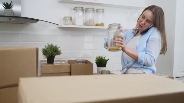 Mujer Hablando Por Teléfono Arregla Utensilios Cocina — Vídeos de Stock