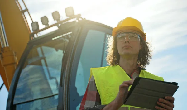 Excavator Operator Hard Hat Using Tablet — 스톡 사진