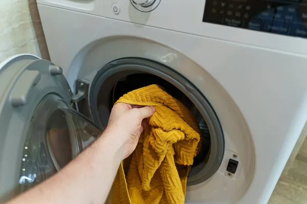 洗濯機にタオルを積み込む男 — ストック写真