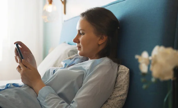 Žena Chytrým Telefonem Surfování Internetu Ložnici — Stock fotografie