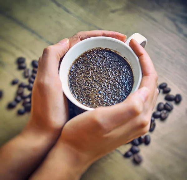 Woman holding cup of freshly brewed coffee. — Stock Photo, Image