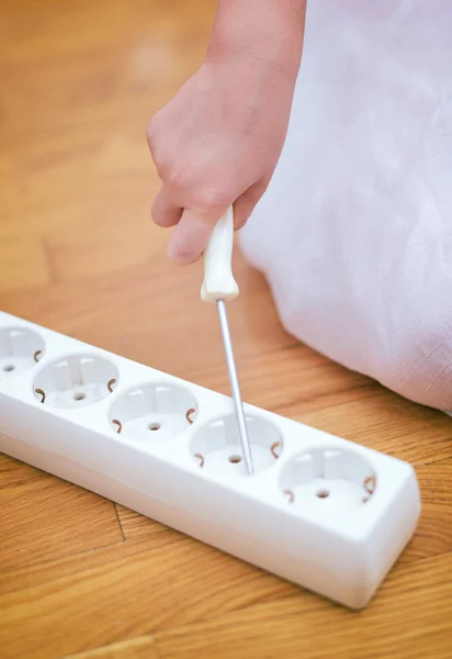 Dangerous situation at home. Child playing with electricity. — Stock Photo, Image