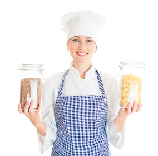 Portrait of female chef cook with pasta and buckwheat. Isolated on white. — Stock Photo, Image