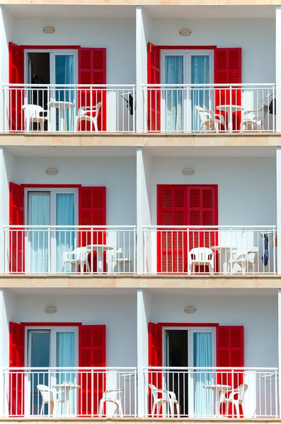 Part of luxury hotel with red shutters. — Stock Photo, Image