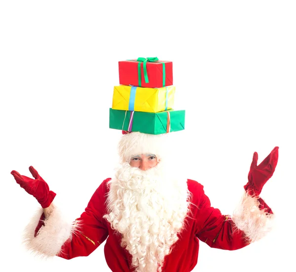 Santa Claus with gifts on his head. Isolated on white. — Stock Photo, Image