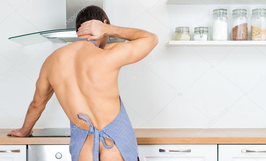 Naked Man Preparing Food In The Kitchen View From The