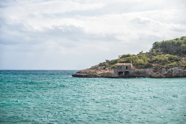 Regn över stranden med fiske lodge. — Stockfoto