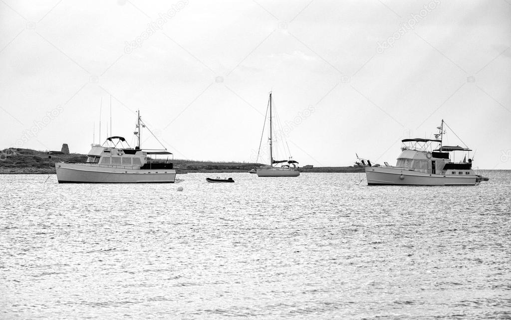 Yachts and boats in the bay at anchor. Black and white.