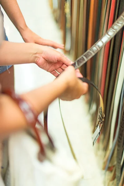 Women choose belt in the store. — Stock Photo, Image