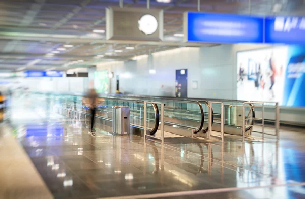 Airport interior with escalator. Motion blur. Royalty Free Stock Images