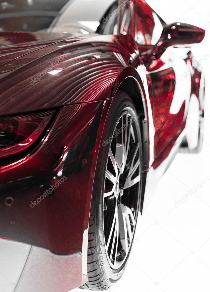 Part of red sports car model on white.