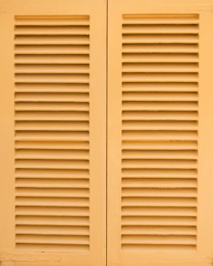 Window with beige shutters. Close-up view. clipart
