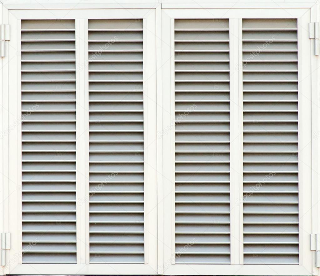 Window with white shutters. Close-up view.