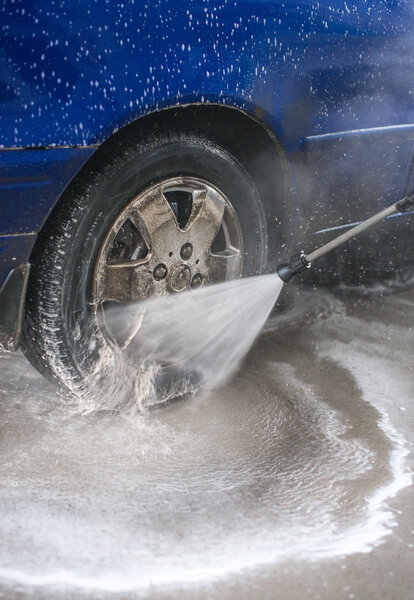 Blue car wash using high pressure water jet.