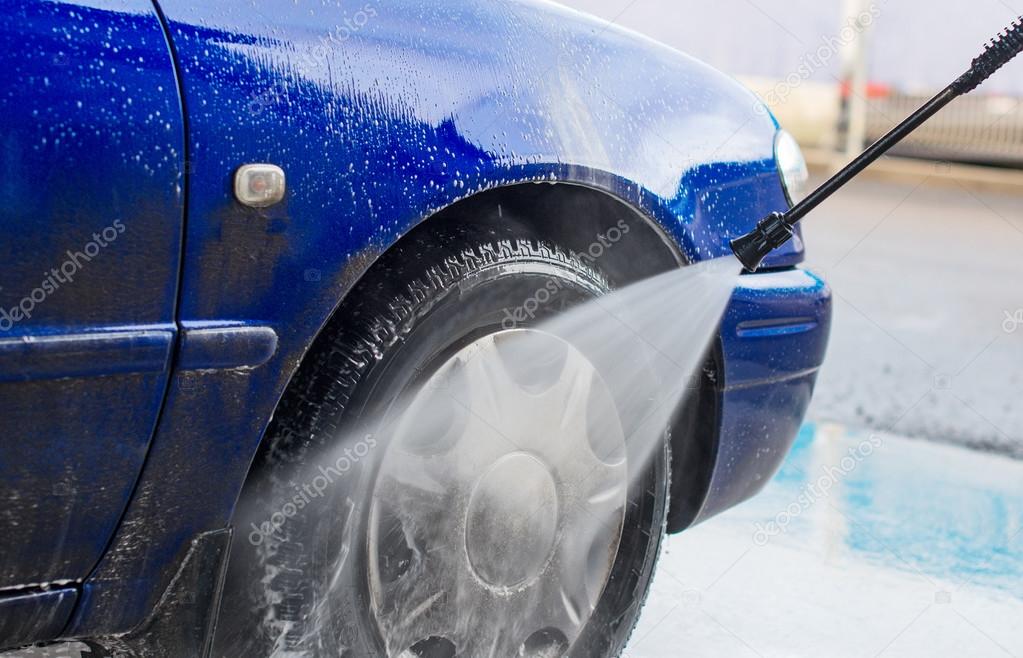 Blue car wash using high pressure water jet. — Stock Photo