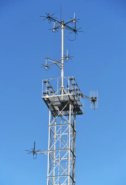 Távközlési torony, az antennák, kék ég alatt. — Stock Fotó