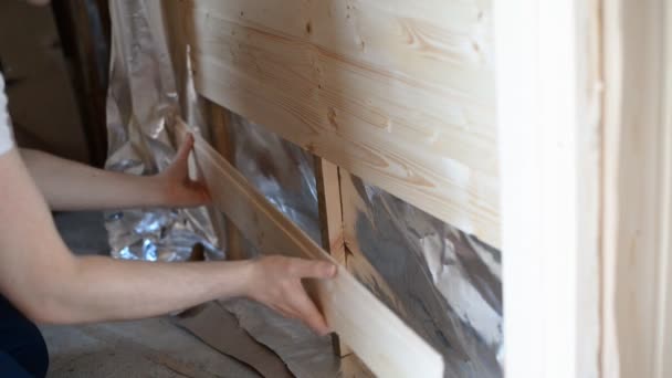 Worker doing siding indoors. — Stock Video