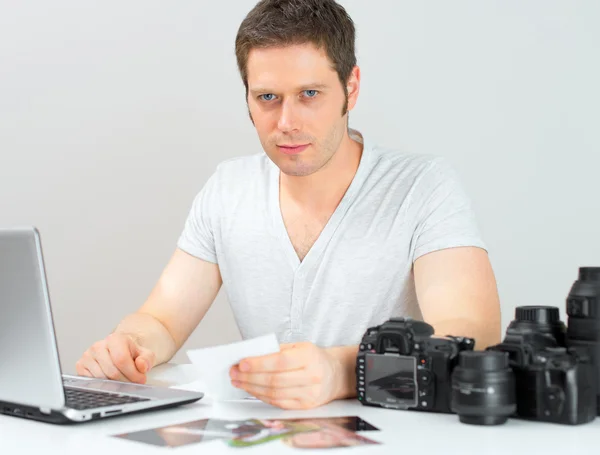 Fotógrafo do sexo masculino trabalhando em seu local de trabalho . — Fotografia de Stock