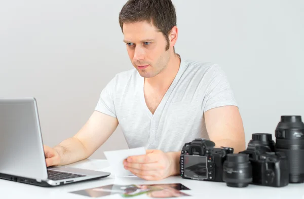 Fotógrafo selecionando fotos em seu computador . — Fotografia de Stock