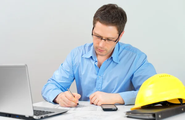 Architect working on house plan at his workplace. — Stock Photo, Image