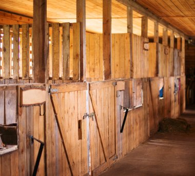 Inside view of Old rural stable. clipart