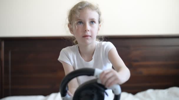 Little girl playing game with steering wheel. — Stock Video