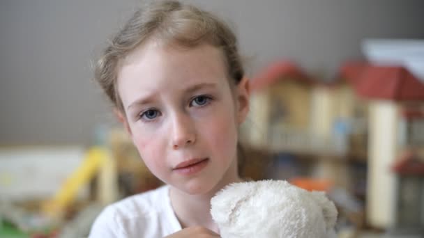 Weinendes kleines Mädchen mit Bär im Kinderzimmer. — Stockvideo